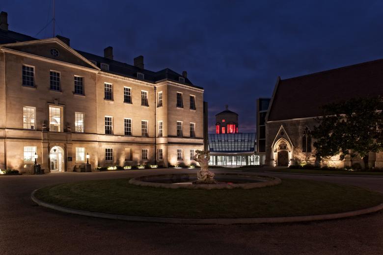 Photo of a pale stone building against the night sky.