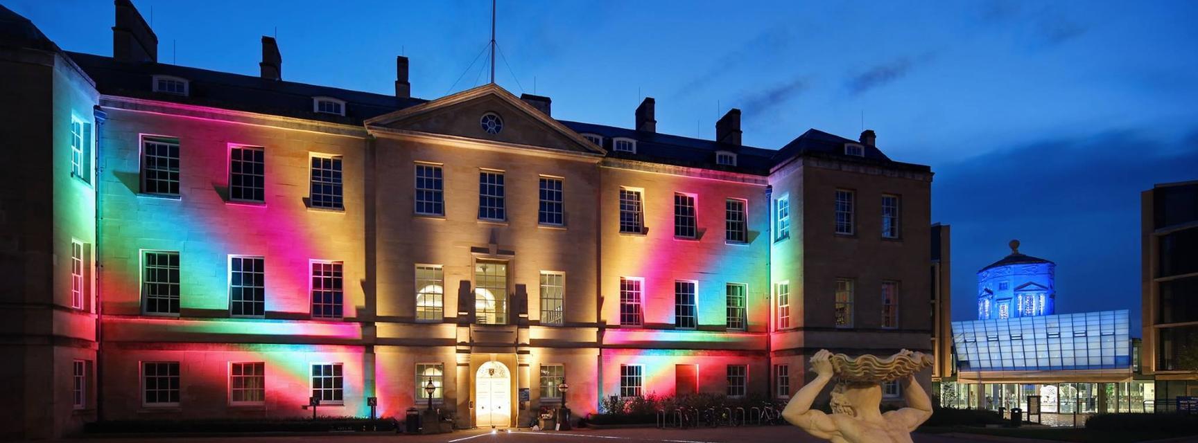 Front of TORCH building lit up with rainbow projections