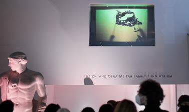 A small screen on a wall, showing a shadow puppet show.