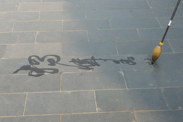 chinese characters being written by a brush on stones