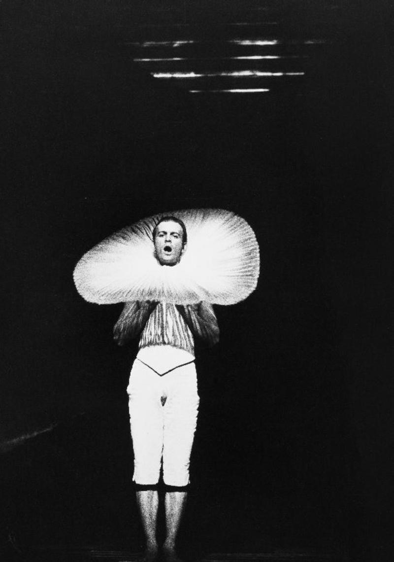 Surreal black and white image of a man dressed as a flower