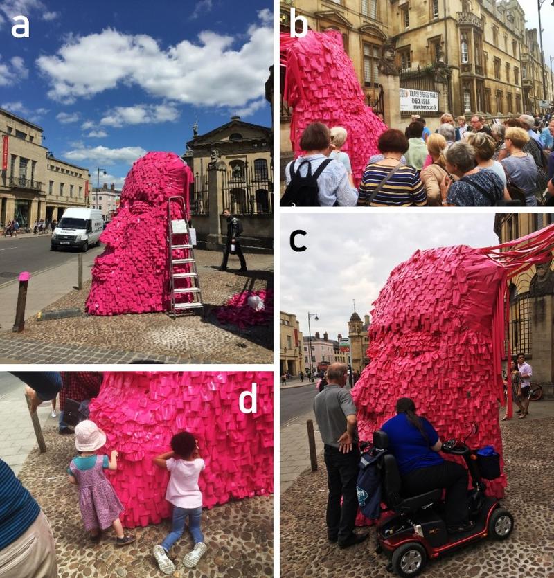 Collage of four pictures depicting people participating in the 'Pink Head' engagememnt activity. The 'Pink Head' was covered in post-it notes. Amongst the audience we see people of all ages.