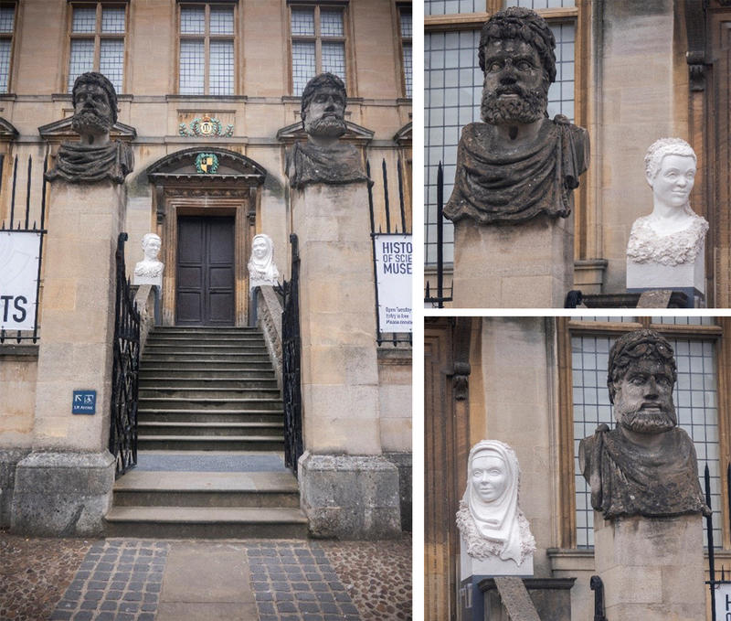 Behind the 'regular' heads two female portraits in gypsum flank the entrance to the building. The old heads are front-facing, whereas the temporary ones are looking to the side.