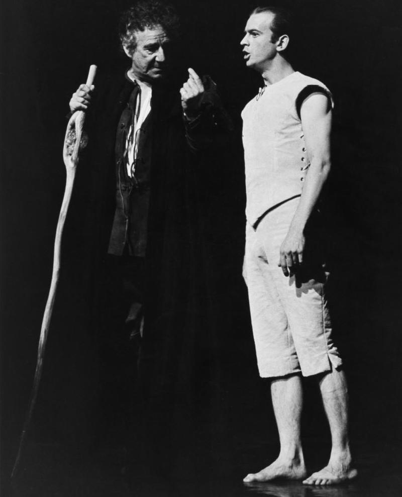 black and white image of two actors in the Tempest, one dressed in black, one dressed in white