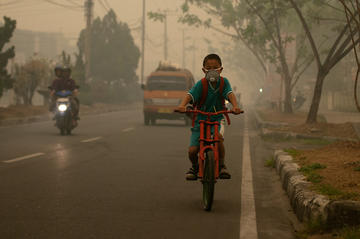 a boy with a mask in smog