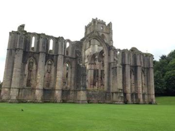The ruins of the church at Fountains Abbey, surrounded by neat lawns