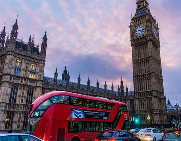 Image depicting a London bus in front of the parliament building and Elizabeth Tower (Big Ben)