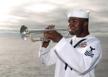 us navy 040718 n 7781d 038 a bugler plays taps during a wreath laying ceremony held on the flight deck in memorial of captain franklin hooks ii