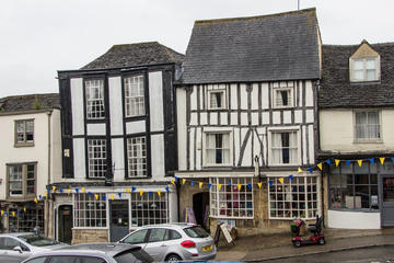 facades of two timber-frame buildings with shops at street level