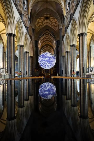 The globe is self-illuminated, hangs in the middle of the main aisle of the cathedral and is perfectly reflector on the floor, which is a mirror. 