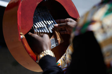Close up of John Falsetto's hands playing the mbira