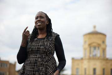 Close up with JC Niala pointing with the Radcliffe Observatory in the background