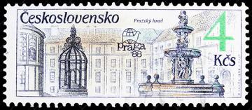 postage stamp showing buildings on the left and a fountain on the right. Stamp against a black background