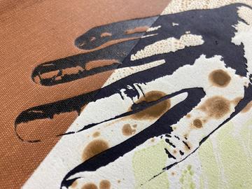 Artwokr of a balck outlined hand ona background of brown