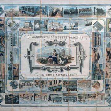 Picture of the Wallis’s Locomotive Game. The principal colour is blue. It depicts a railway journey with each stop featuring a railway-related image.