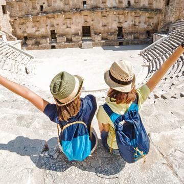 Image depicting two pupils sitting on the steps of an amphitheatre.