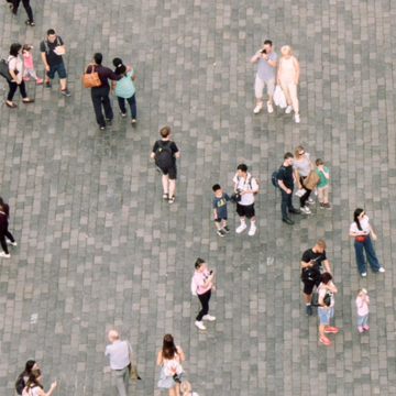 aerial shot of people walking on a paved area