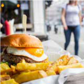 Image of a burger with egg and chips
