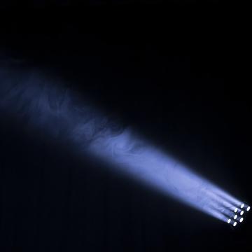 Stage lights into smoke showing a single beam