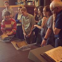 delegates are shown the rare books collection at christ church library