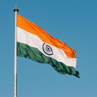 The Indian flag waves against a clear blue sky