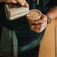 man pooring coffee into a take away cup