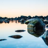 shore with mirroring stones