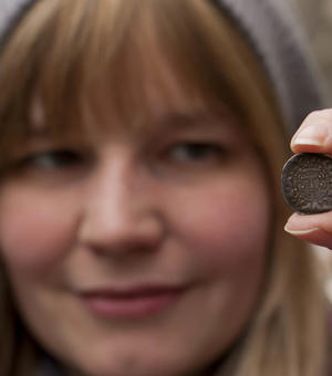  Photograph of Megan Gooch holding up a coin