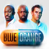Promotional production image: 3 men stare at camera; in the foreground a blue and orange pill