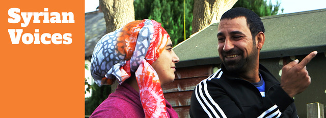 a man and woman talking in front of a house - shoulders only